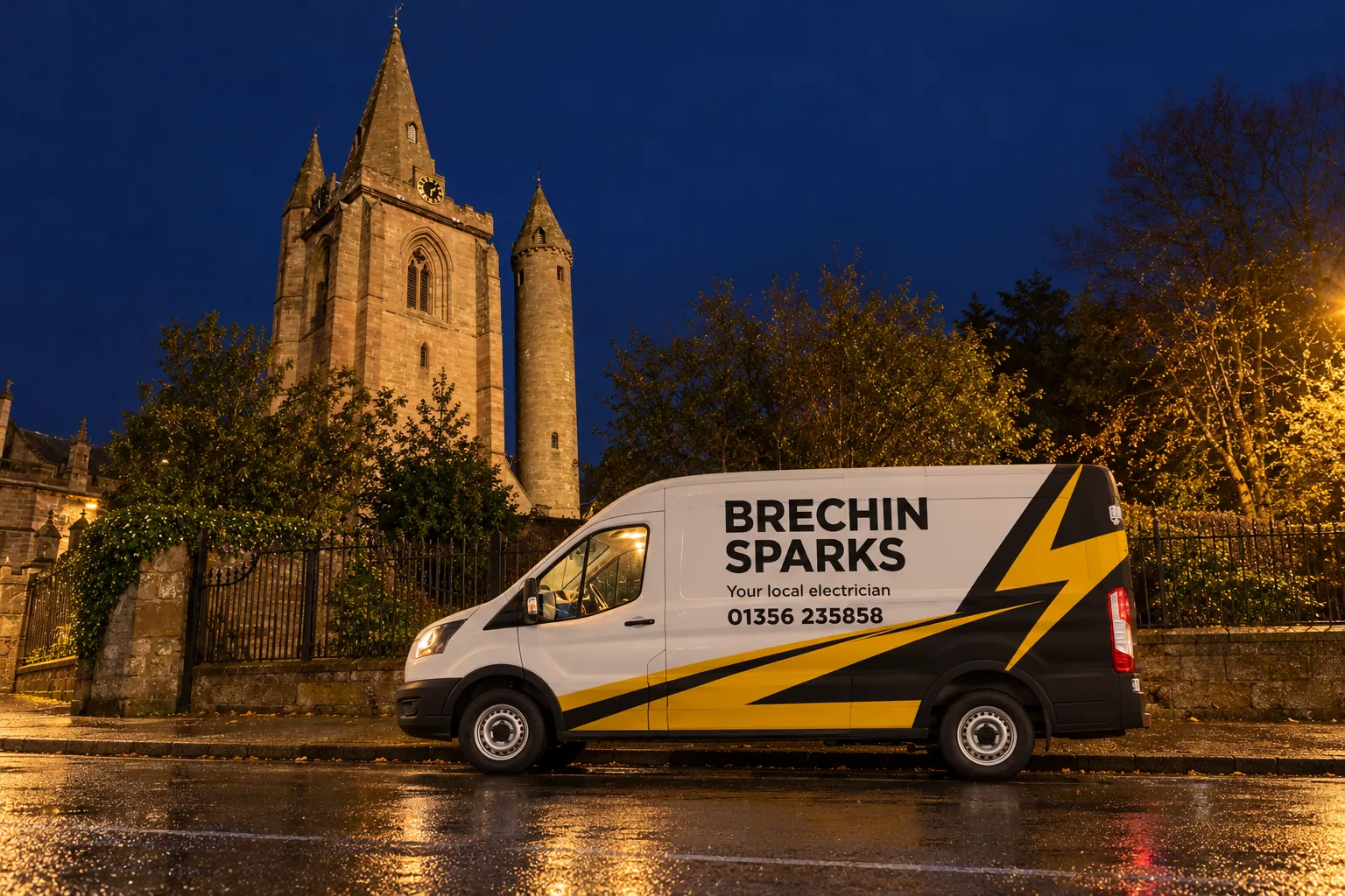 Brechin Sparks van parked at night beside Brechin Cathedral and its round tower